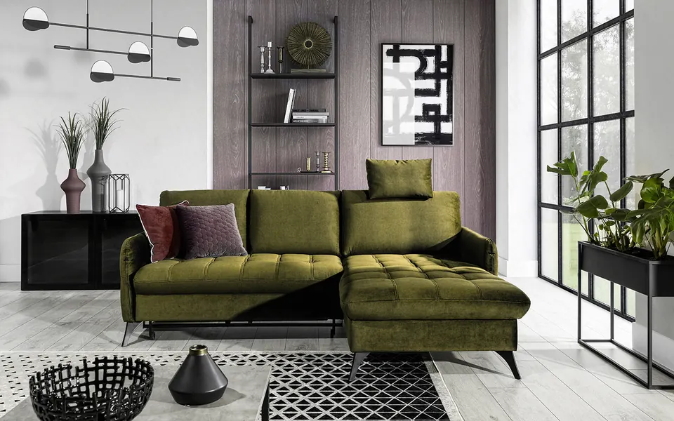 A deep green LORI Mini corner sofa bed in a bright living room